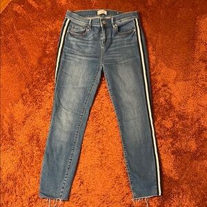 Medium wash mid-rise jeans with racer stripe